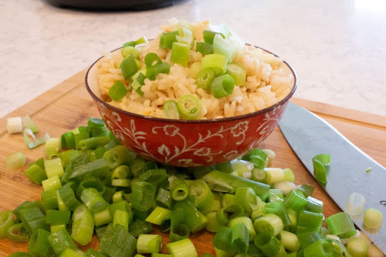 a bowl of Filipino Garlic Fried RIce with green onions