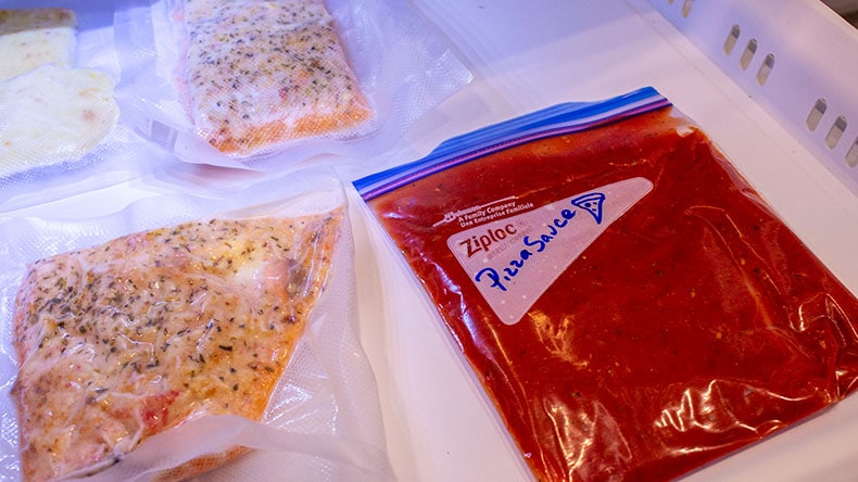 Pizza sauce frozen in a bag laid flat in a freezer