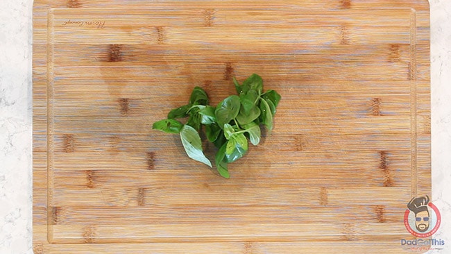 fresh basil on a wood cutting board to make shrimp scampi