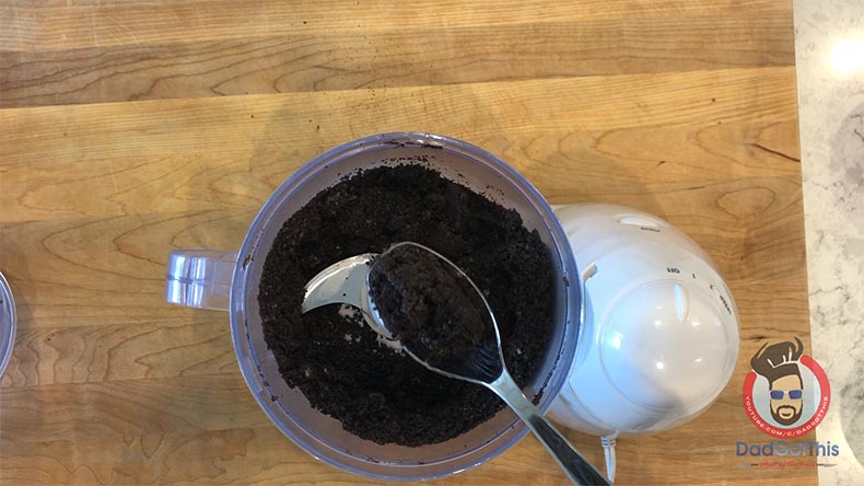 Oreos in a food processor with a spoon