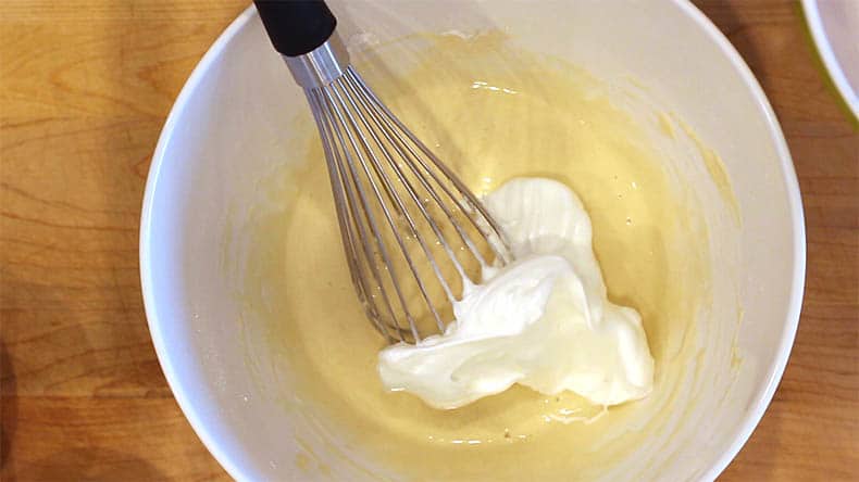 a whisk with meringue and pancake batter in a bowl