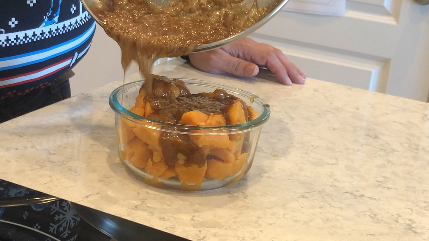 pouring sugar mix over yams