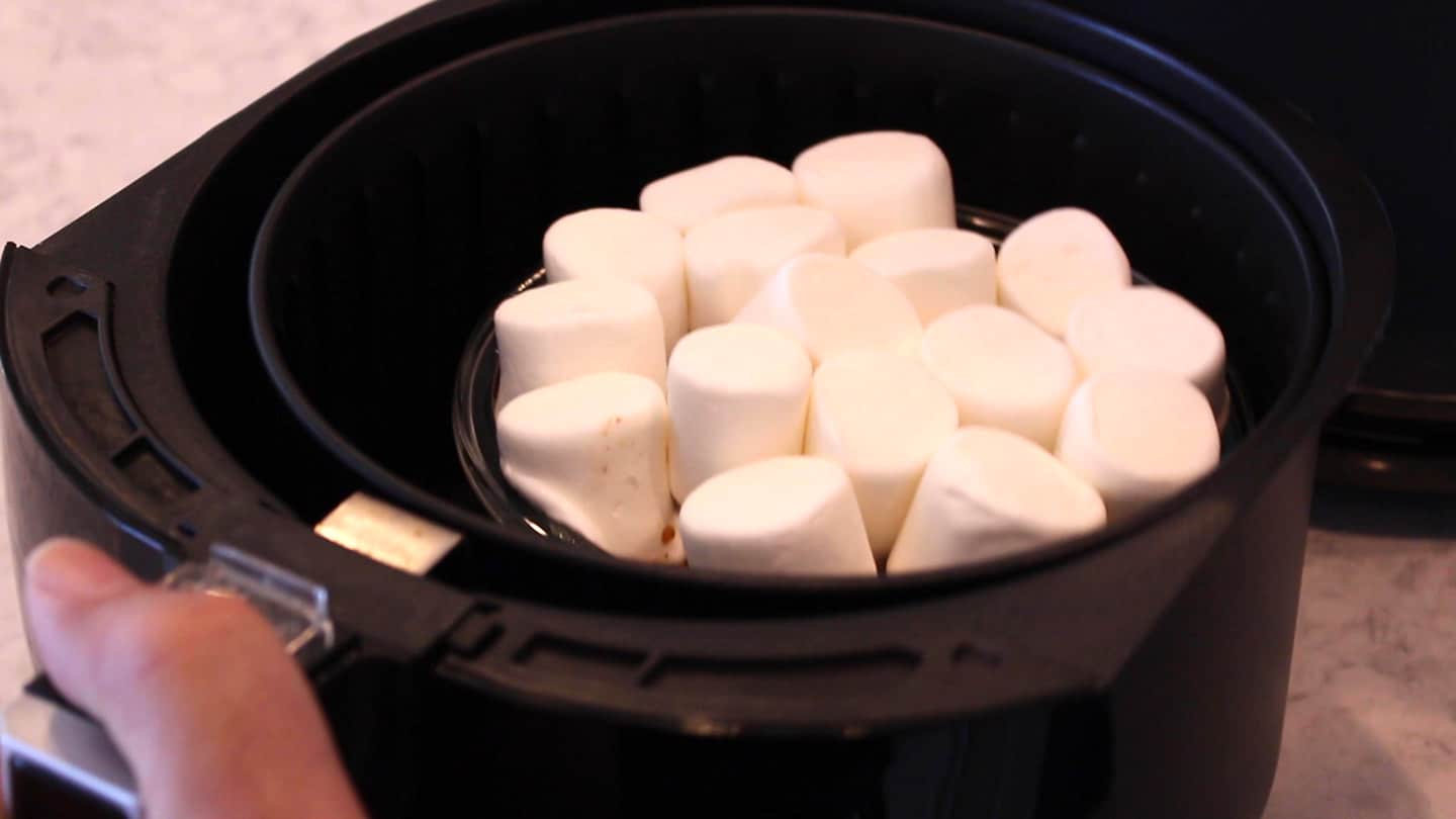 adding marshmallows on candied yams in an air fryer