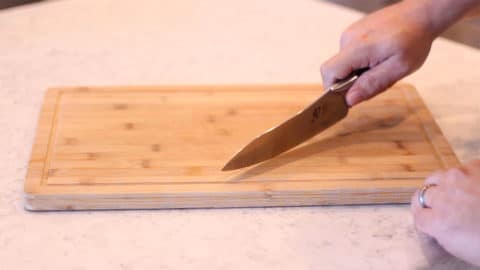 knife cutting on a cutting board