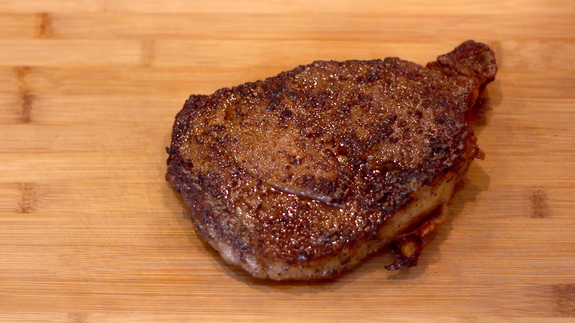 A reverse seared steak on a cutting board