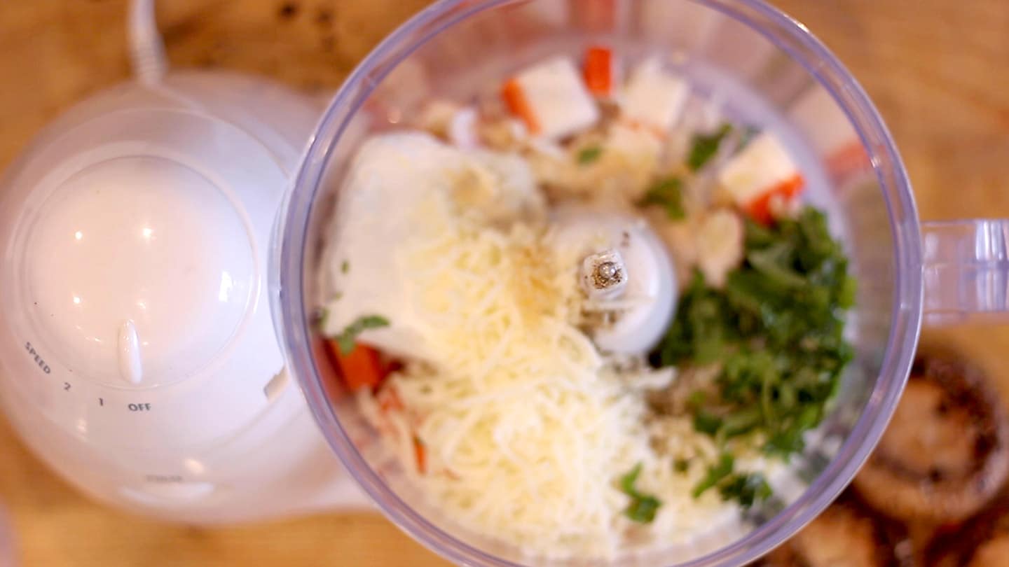 Ingredients for seafood stuffed mushrooms in a food processor