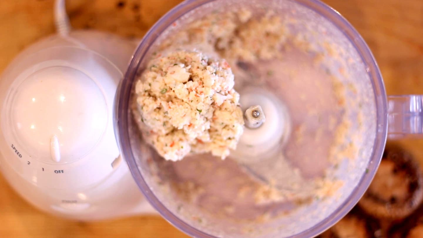 a ball of ingredients in a food processor for seafood stuffed mushrooms