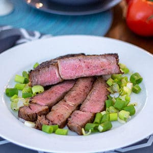 a reverse seared steak on a white plate