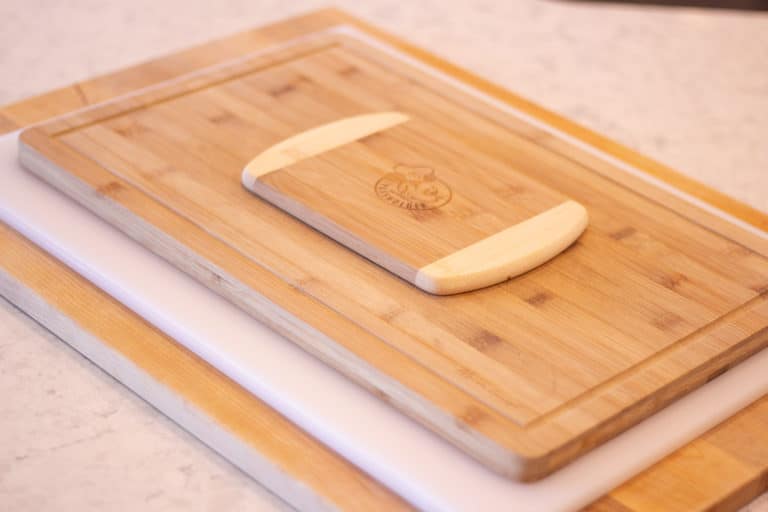 a stack of cutting boards on a counter