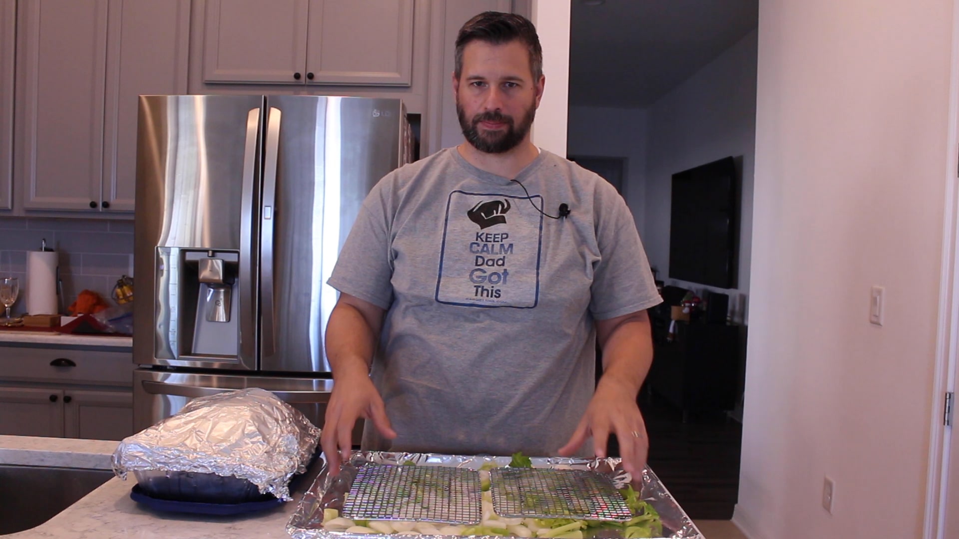 Dad in front of a sheet pan with veggies and wire racks