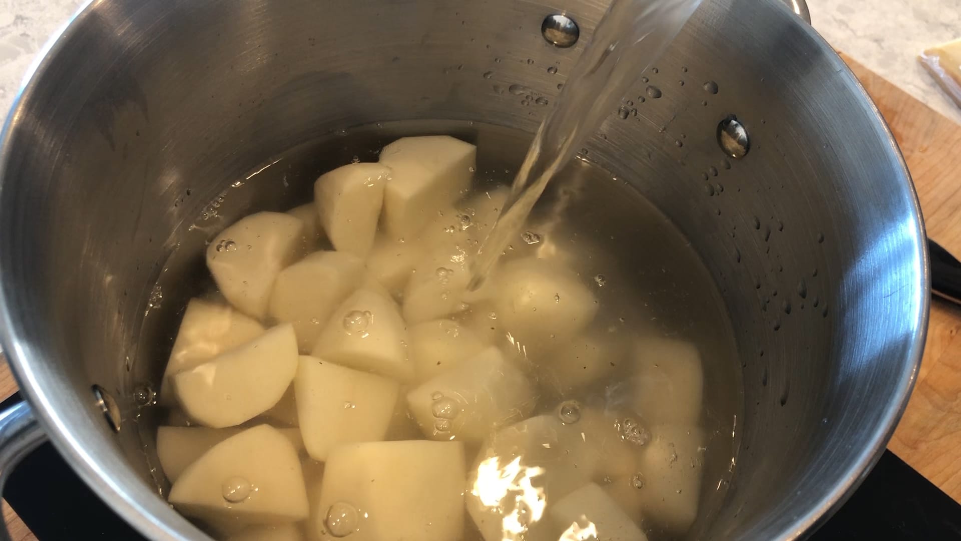 potatoes in a pot being covered by water