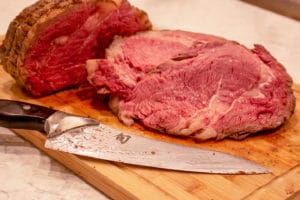 sous vide prime rib on a cutting board with a knife