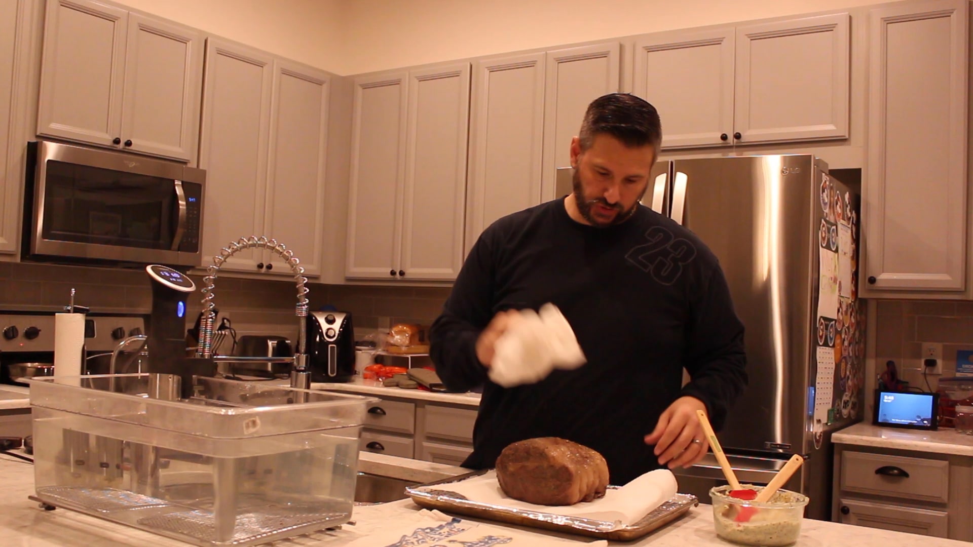 dad drying the sous vide prime rib roast with paper towels