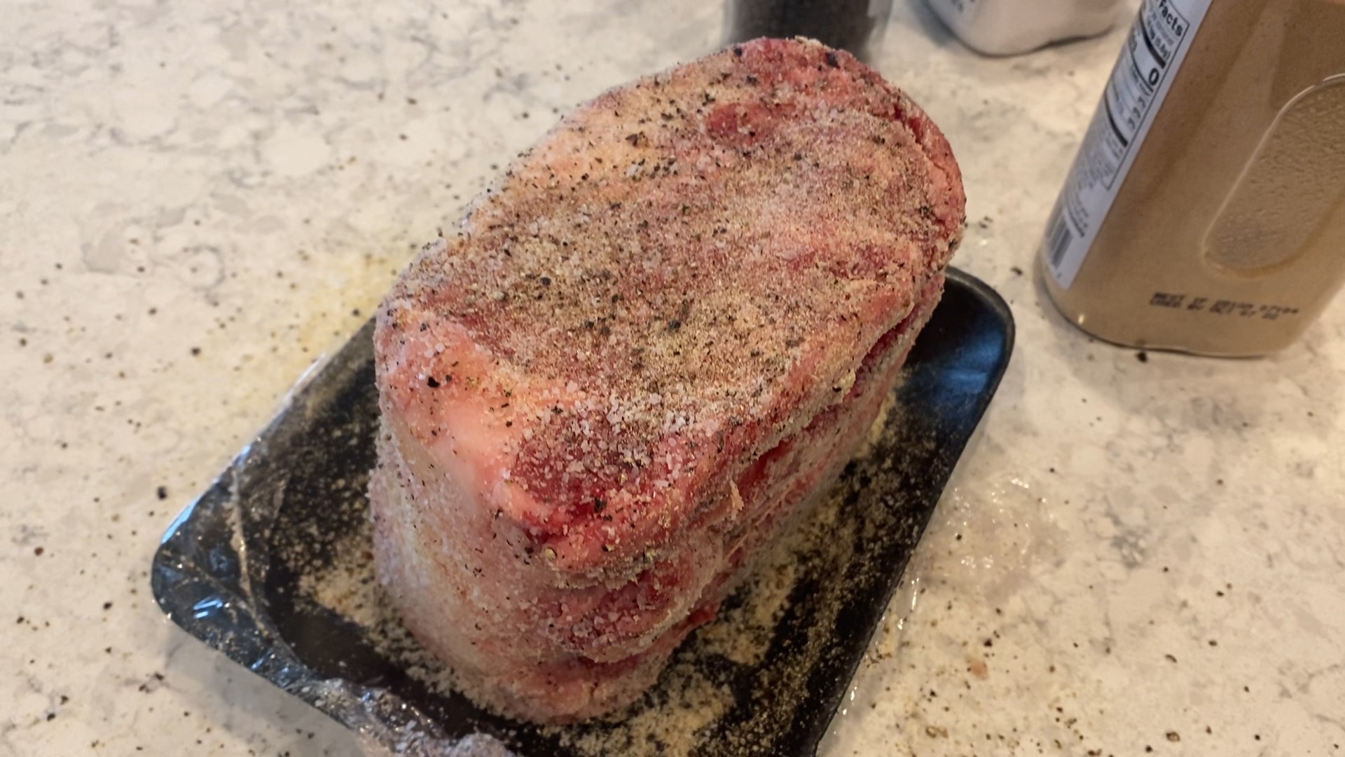 seasoned prime rib roast on a counter