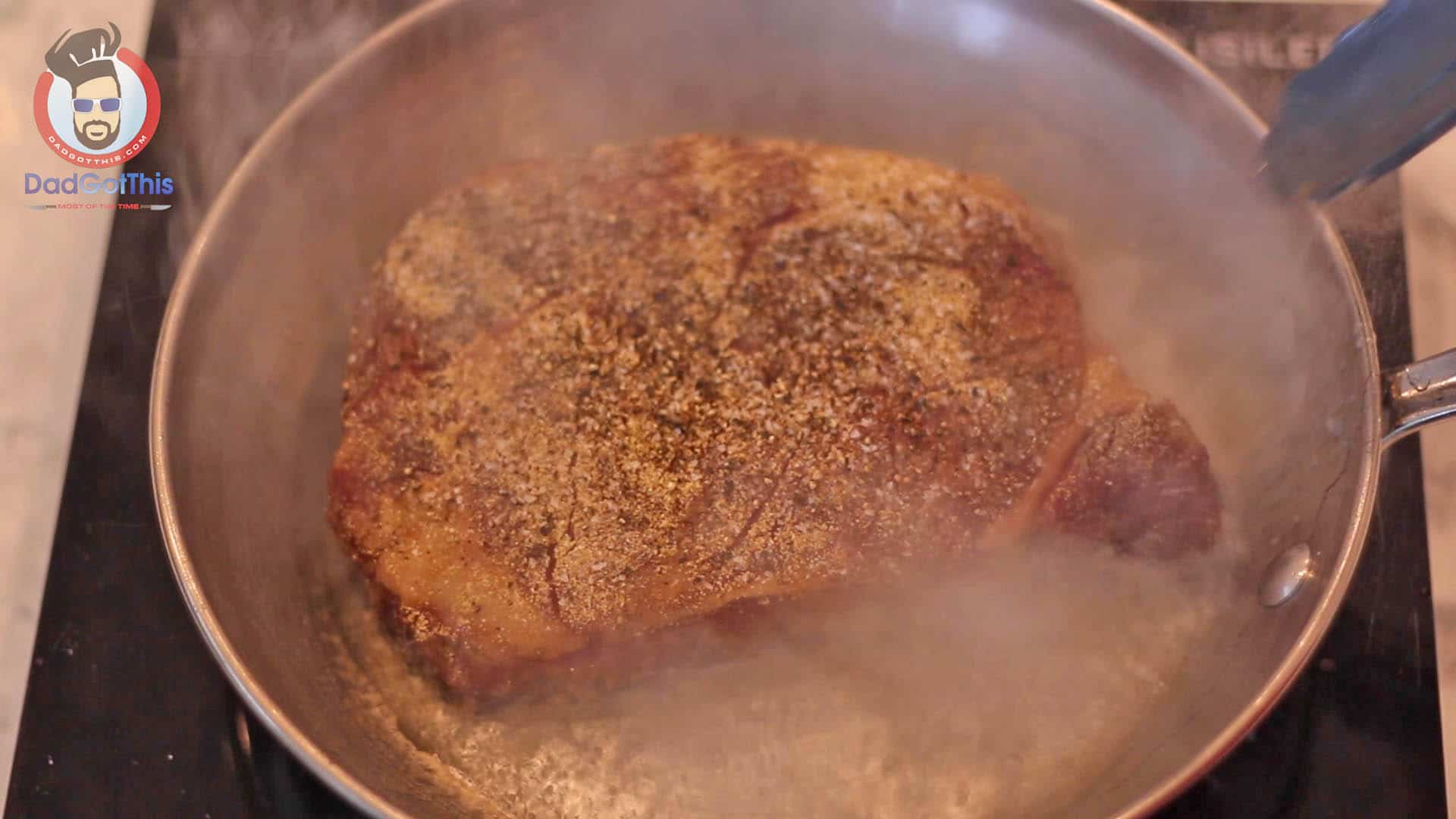 a sous vide steak being seared in a hot pan