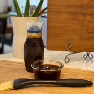 Homemade BBQ Sauce on a counter with a brush