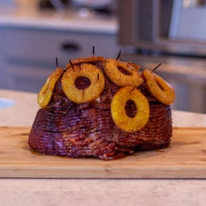 a pineapple topped spiral sliced ham on a counter