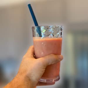 Fruit Smoothie in a Glass with a blue straw