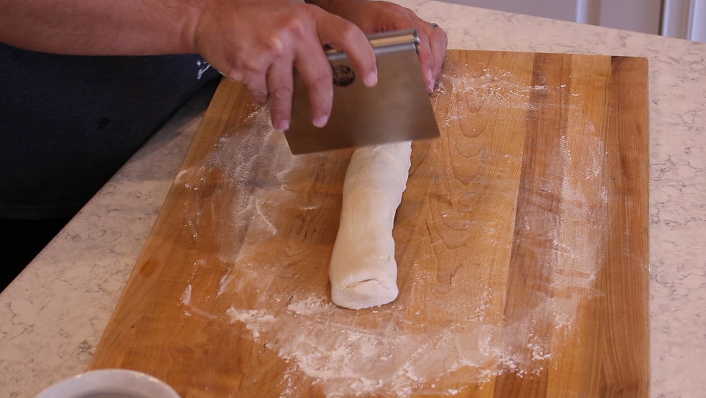 dough on a cutting board being cut