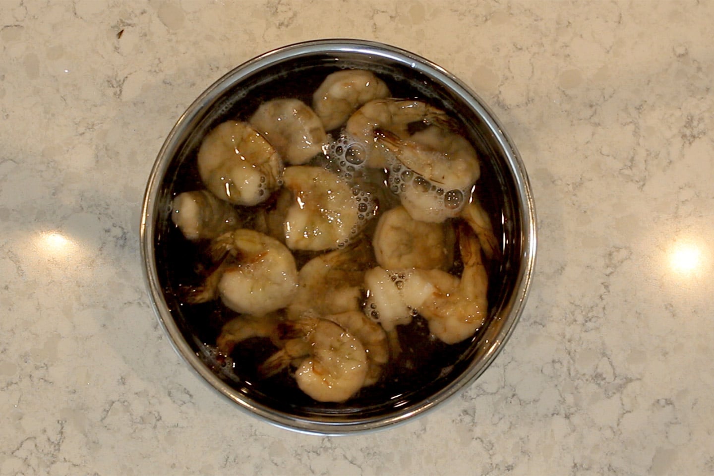frozen shrimp in a bowl of water for easy shrimp tacos