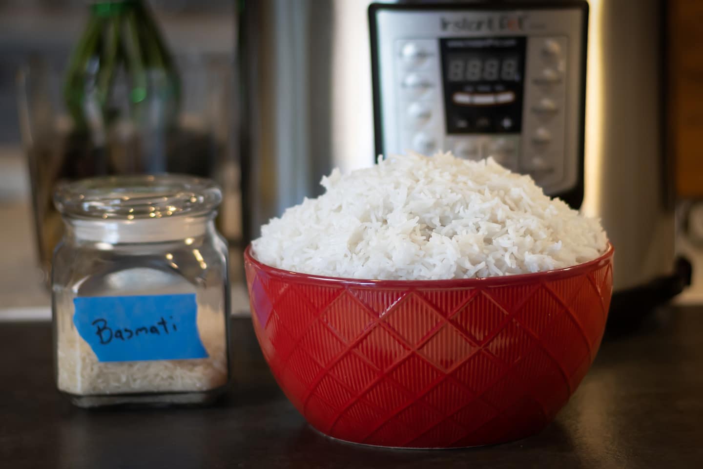 Basmati Rice in front of an Instant Pot in a red bowl