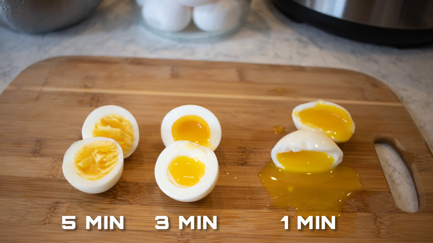 3 boiled eggs cut open on a cutting board