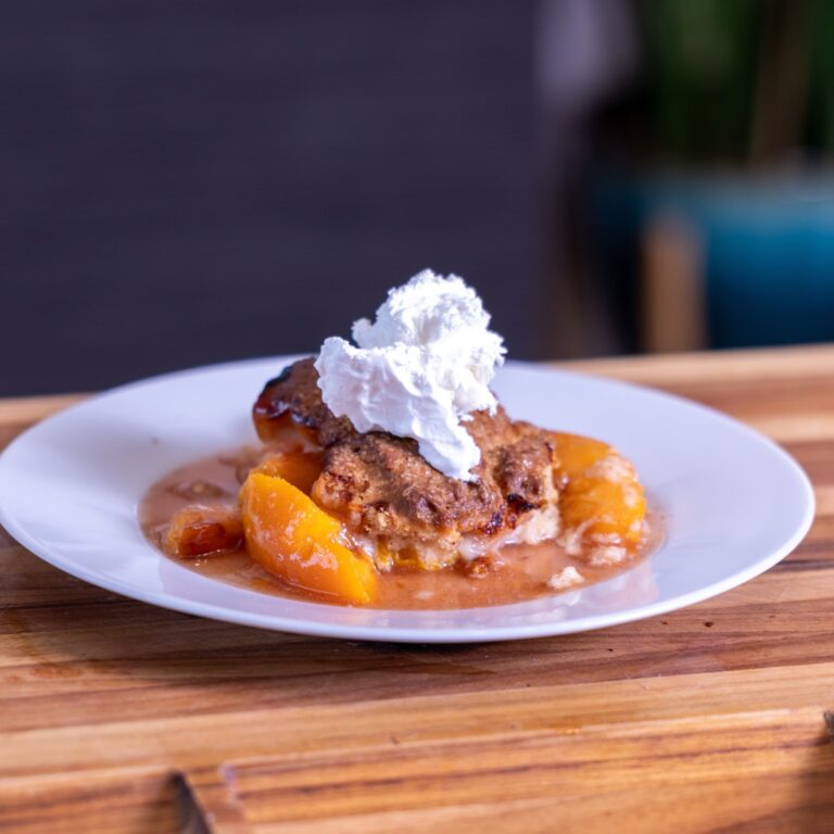 Smoked Peach Cobbler topped with Cool Whip