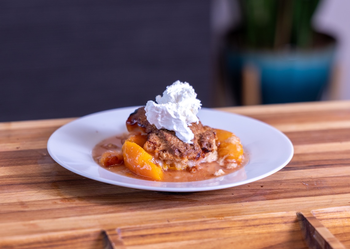Smoked Peach Cobbler topped with Cool Whip