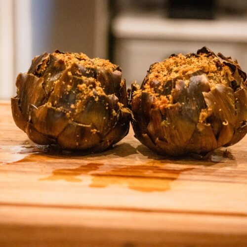 Two Woodfire smoked Italian stuffed artichokes with golden breadcrumb filling