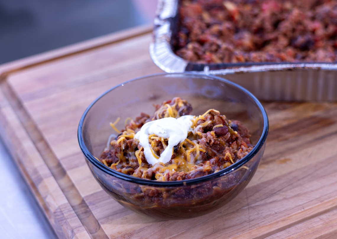 Ninja Woodfire Over the Top Chili topped with cheddar cheese and sour cream