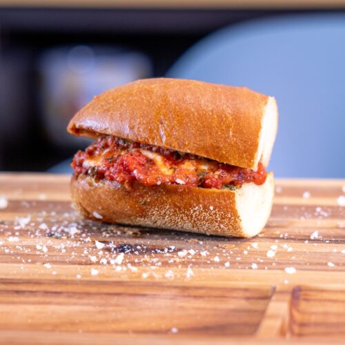 Woodfire Meatball Sub with tomato sauce and melted cheese on garlic bread